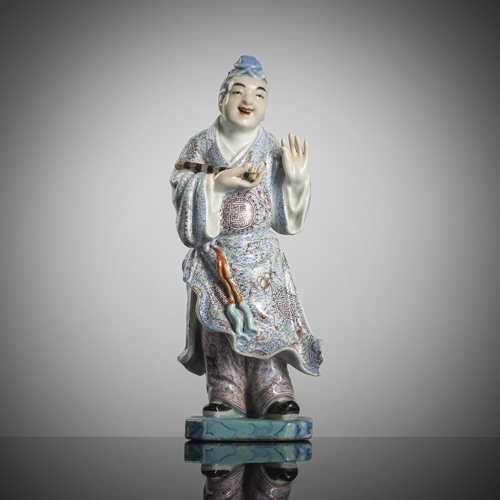 <b>A polychrome decorated figure of a standing man with flute made of porcelain</b> <b>A polychrome decorated figure of a standing man with flute made of porcelain</b>