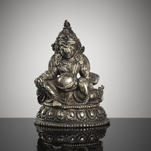 <b>A small silver figure of Pita Jambhala on a lotus</b>