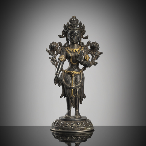 <b>A part-gilt silver figure of the standing Padmapani on a lotus</b>