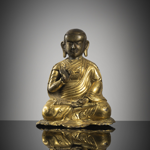 <b>A part-gilt bronze of a seated lama</b>