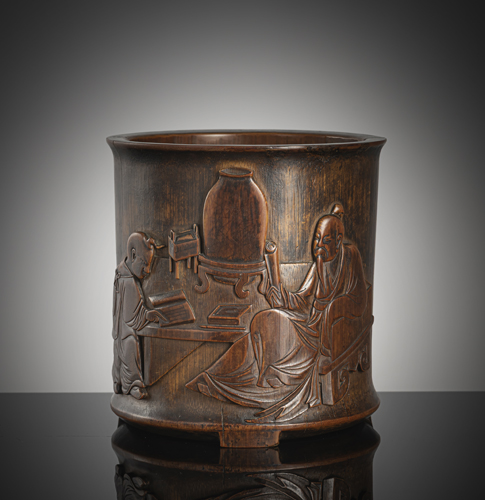 <b>A fine carved cylindrical bamboo brush cup with decoration of a scholar with a servant boy and a poem on the reverse</b>