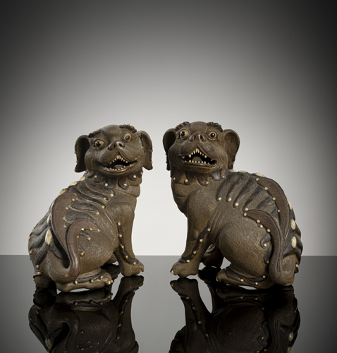 <b>A couple of light-brown ceramic male and female fo lions</b>