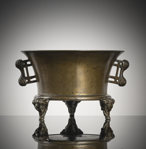 <b>A bronze incense burner standing on three elephant heads, side handles in 'zhan' style with ram's horn finials</b>