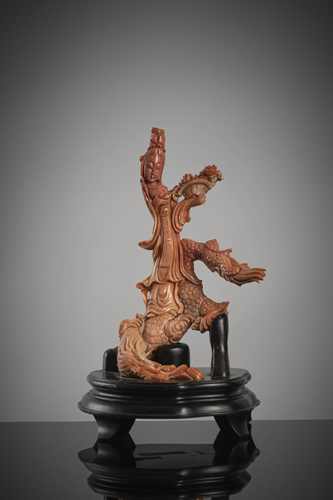 <b>A coral carving in the shape of an immortal standing on a dragon</b>