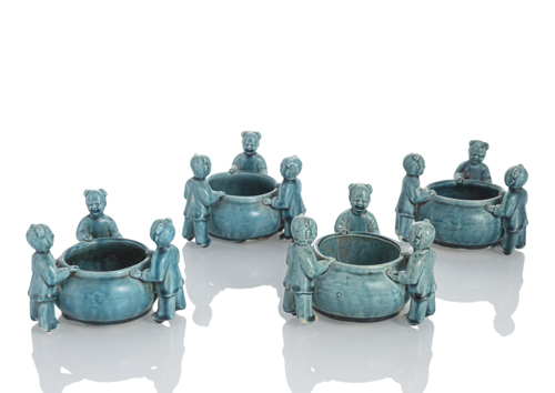<b>A group of four biscuit porcelain brush washers, each with three boys, glazed in turquoise colour</b>