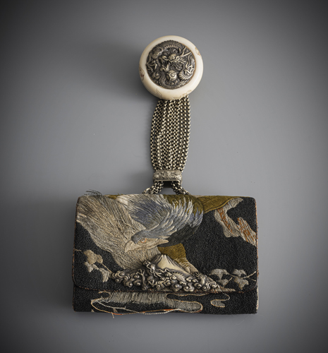 <b>A leather tobacco pouche covered with fabic embroidered in Sagara technique with eagle over Mount Fuji, Kagamibuta netsuke made of engraved ivory relief decoration</b>