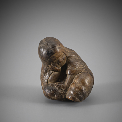<b>A fine netsuke of the slumbering Shôjô in medium brown wood</b>