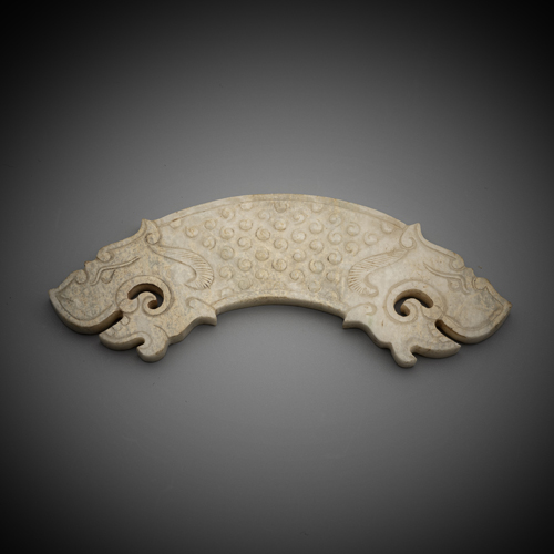 <b>A CURVED JADE CARVING 'HUANG' WITH TWO STYLIZED TIGER HEADS</b>