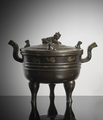 <b>A bronze incense burner with 'splash' decoration on three curved legs</b>