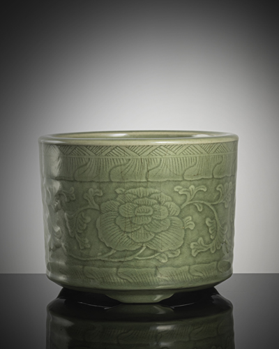<b>A celadon-glazed cachepot with peonies in relief</b>