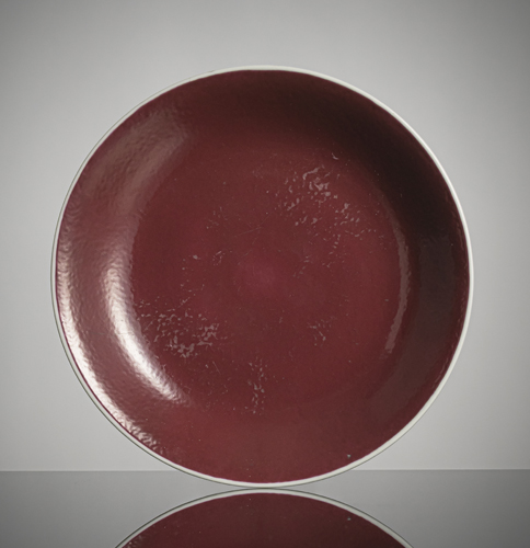 <b>A reddish-purple glazed porcelain saucer</b>