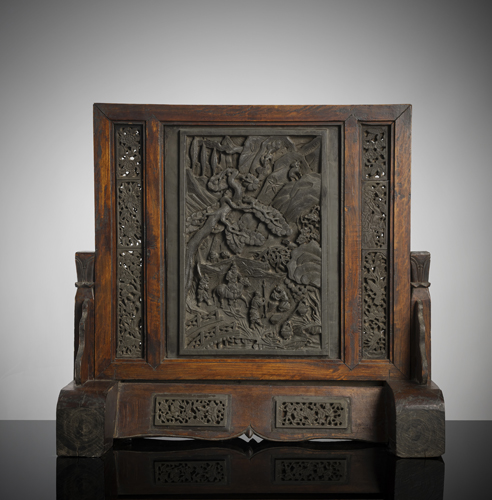 <b>A table screen with well carved grey stone panels in wooden mounting</b>