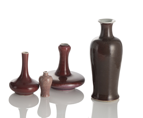 <b>A group of four vases with copper-red glazes in different shapes, the largest vase with 'anhua' decoration of dragons</b>
