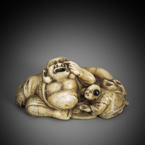 <b>A fine carved ivory netsuke of the reclining Hotei with a boy</b>