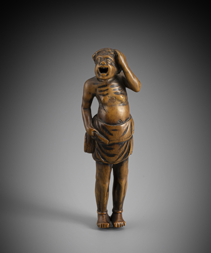 <b>A large netsuke of a standing sennin with drum</b>