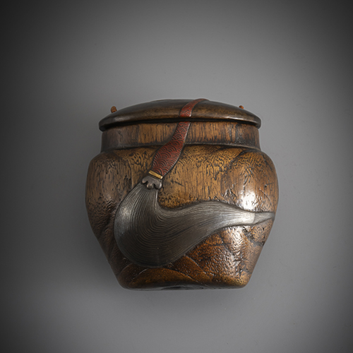 <b>A wooden tonkotsu with lacquer decoration of a fly whisk, a scroll and a hibachi, partly in gold lacquer</b>