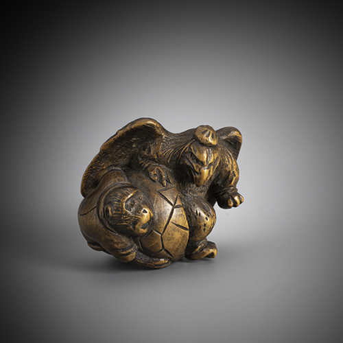 <b>A brown wood Netsuke of a tengu with monkey</b>