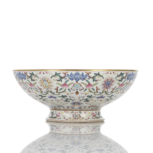 <b>A large porcelain footed bowl with 'famille rose' decoration of lotus flowers, peaches, and bats</b>