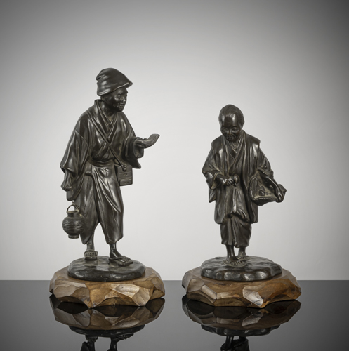 <b>Two bronze okimono of a man with a book and lantern as well as a woman collecting mushrooms</b>