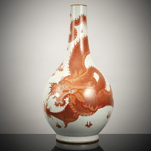 <b>A large porcelain bottle vase with iron-red dragon and carp decoration on a white enamelled wave ground</b> <b>A large porcelain bottle vase with iron-red dragon and carp decoration on a white enamelled wave ground</b>