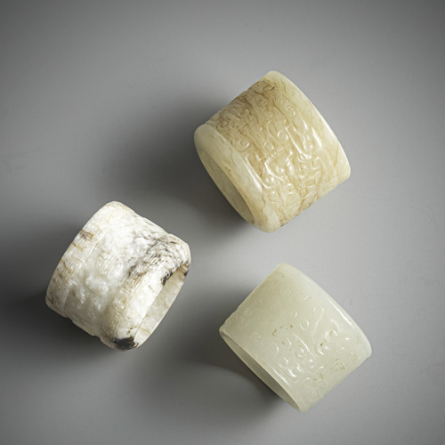 <b>Three fine jade archer rings with relief decoration</b>