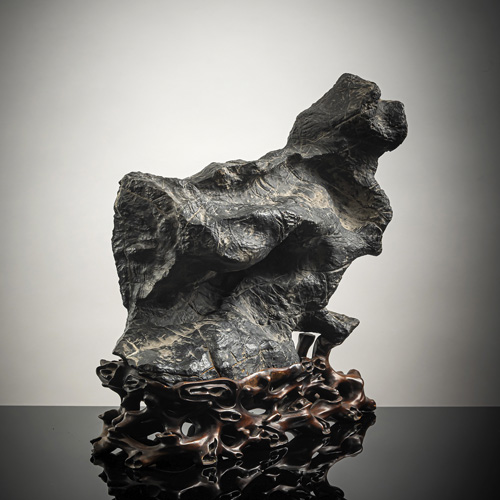 <b>A 'lingbi' scholar's rock on a fitted wooden base, 'gongshi'</b>