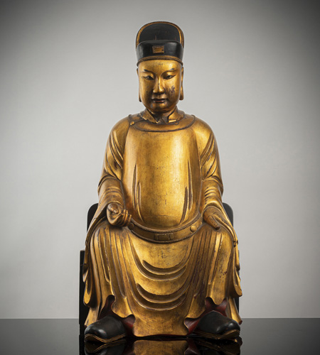 <b>A GILT- AND BLACK-LACQUERED WOOD FIGURE OF A DIGNITARY</b> <b>A GILT- AND BLACK-LACQUERED WOOD FIGURE OF A DIGNITARY</b>