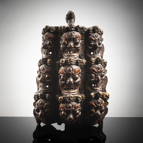 <b>A polychrome decorated mask or ornament made of wood</b>