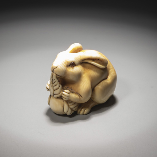 <b>A carved ivory netsuke of a hare with a raddish</b>