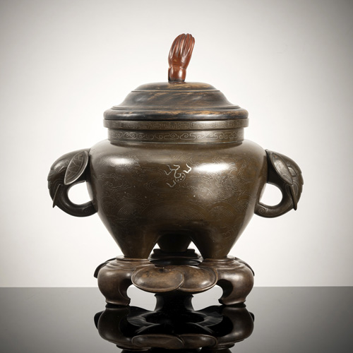 <b>Three-legged incense burner made of bronze with silver wire inlays and elephant head handle</b>