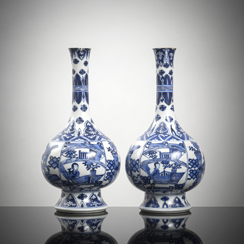 <b>A pair of underglaze blue porcelain bottle vases with scenes of women, emblems and antiques in intense blue</b>