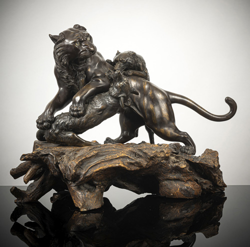 <b>A large bronze model of a tiger fighting two wolves</b>