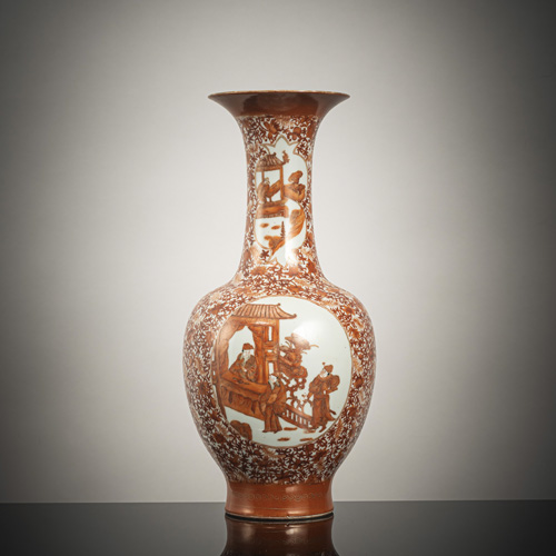 <b>An iron-red porcelain baluster vase depicting literary scenes within oval reserves on a floral scroll ground</b> <b>An iron-red porcelain baluster vase depicting literary scenes within oval reserves on a floral scroll ground</b>