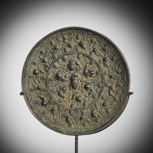 <b>A large silvered bronze mirror with grape-lion decoration, metal stand</b>