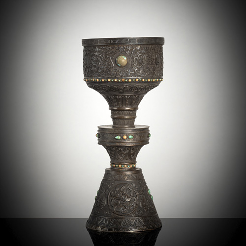 <b>A large gemstone-inlaid silver butter lamp with Buddhist symbols in relief, 'Ashtamangala'</b>