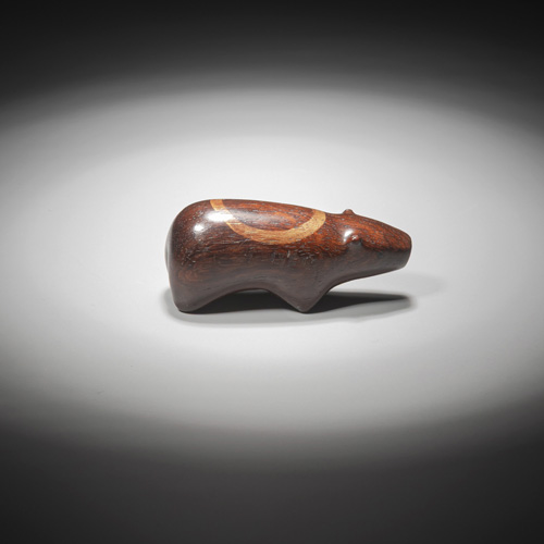 <b>An unusual netsuke of a polar bear made of dark brown wood</b>