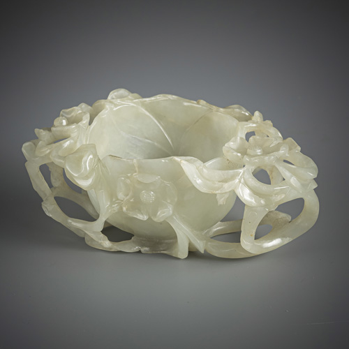 <b>A pale celadon jade 'prunus' washer</b>