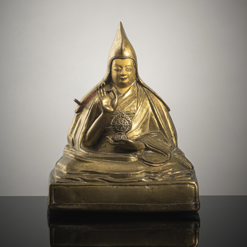 <b>A BRONZE FIGURE OF A LAMA</b>