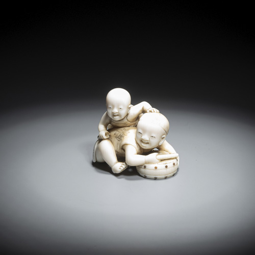 <b>A small ivory okimono of two playing children</b>