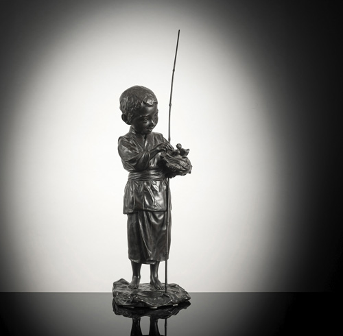 <b>A bronze okimono of a boy holding a bird's nest with fledglings</b>
