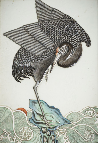 <b>A fine porcelain panel with a crane in sculptural relief standing over waves on a rock, decorated in the colours of the 'Famille verte'</b> <b>A fine porcelain panel with a crane in sculptural relief standing over waves on a rock, decorated in the colours of the 'Famille verte'</b>