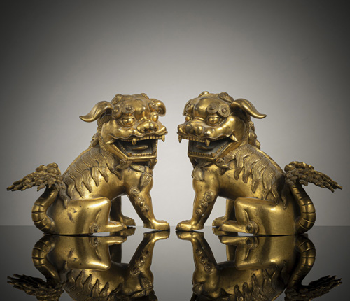 <b>A very fine pair of seated gilt-bronze lions</b>