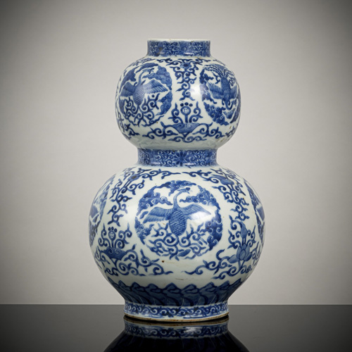 <b>A porcelain calabash vase with underglaze blue decoration of phoenixes among clouds and foliage</b>