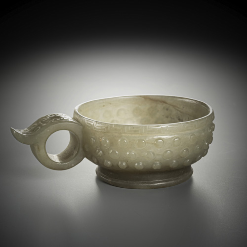 <b>A WELL CARVED JADE BOWL WITH HANDLE IN LIGHT GREEN</b>
