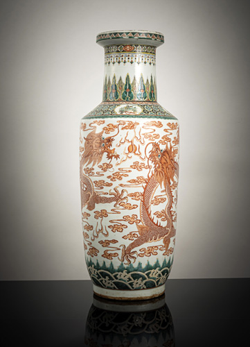 <b>A large porcelain rouleau vase with 'famille verte' and iron-red decoration of two dragons amidst clouds</b> <b>A large porcelain rouleau vase with 'famille verte' and iron-red decoration of two dragons amidst clouds</b>
