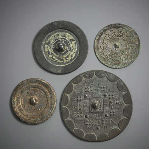 <b>Four bronze mirrors, some with silver overlay and a 'dou'</b>