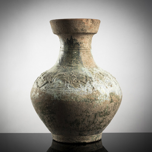 <b>An earthenware pottery vase with iridescent green glaze and hunting scenes</b>