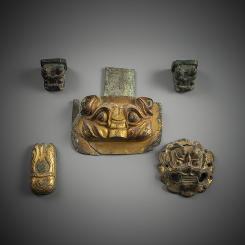 <b>A group of five fittings or bronzes, partly gilded</b>