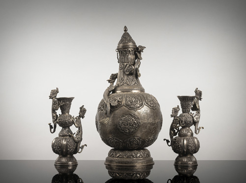 <b>A fine silver ewer and cover and pair of candlesticks, worked in repoussé technique</b>