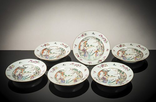 <b>Six deep export porcelain dishes with 'famille rose' decoration of figures in a garden with a dog</b> <b>Six deep export porcelain dishes with 'famille rose' decoration of figures in a garden with a dog</b>
